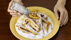 Woman Salting Junk Food