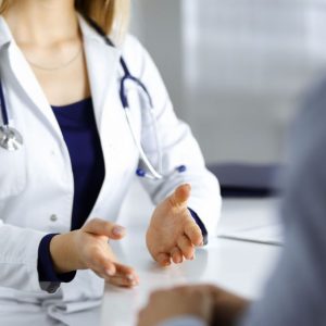 bigstock-unknown-woman-doctor-is-talkin-388799836_1_621x621