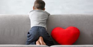 bigstock-Little-boy-sitting-on-sofa-at-222103045-1170x600