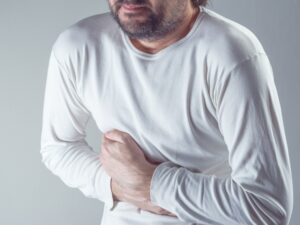 Man Suffering From Severe Abdominal Pain, Hands On Stomach