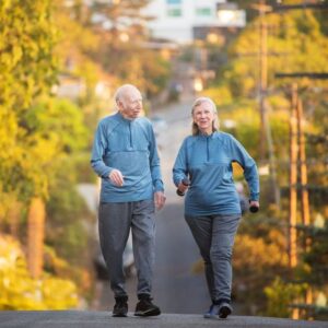 bigstock-happy-couple-walking-on-street-149409542_1_621x621