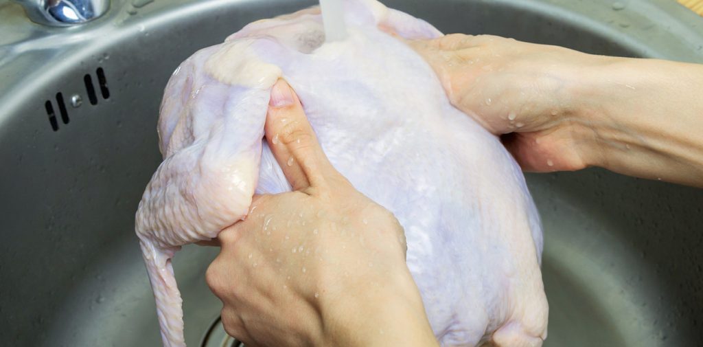 Woman,Washing,Fresh,Raw,Hen,In,Kitchen,Sink.,Cooking,Chicken